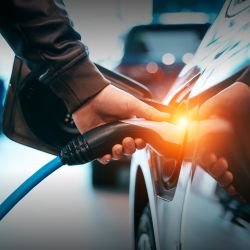 A hand pluging in an electric veichle